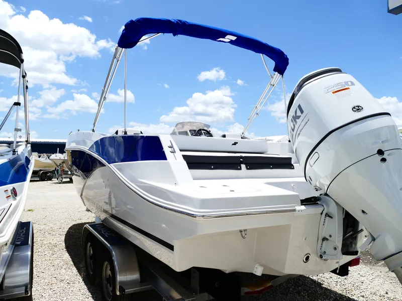 Slide: The Image of 2026 Starcraft SVX 231 OB DH boat with Suzuki outboard motor, parked on a trailer. - 12