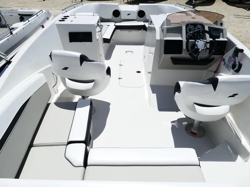 Slide: The Image of 2026 Starcraft SVX 231 OB DH boat interior with modern seating and steering console. - 14