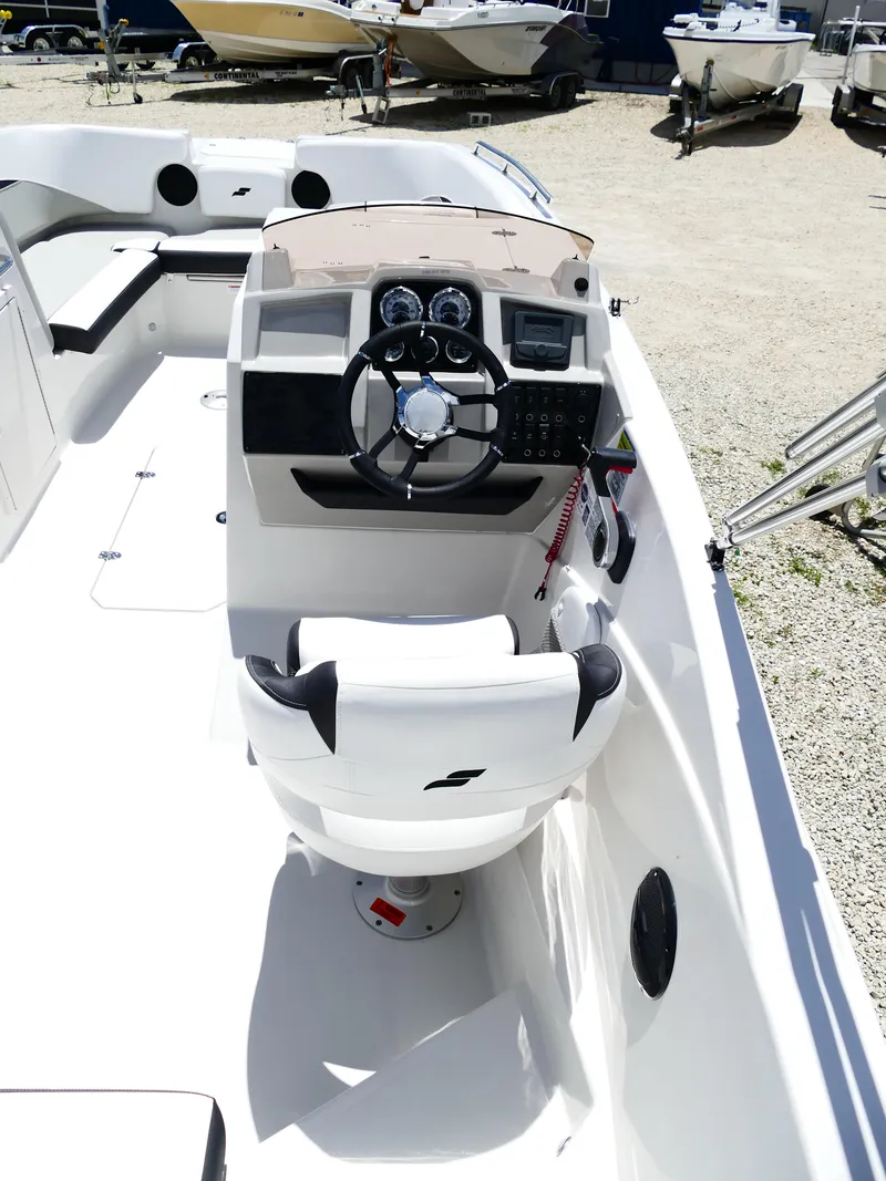 Slide: The Image of 2026 Starcraft SVX 231 OB DH boat interior with steering wheel and seating. - 16