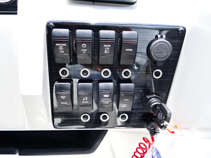 Slide: The Image of Control panel of 2026 Starcraft SVX 231 OB DH boat with labeled switches and ignition key. - 21