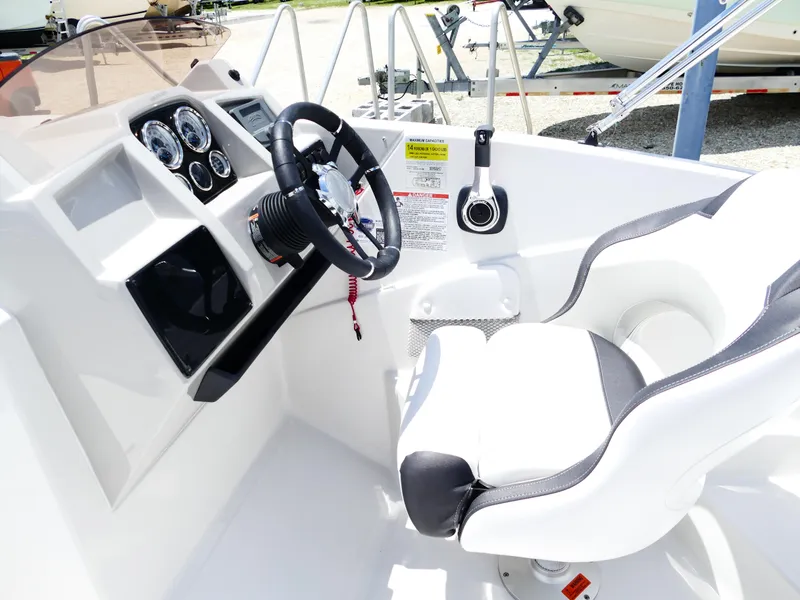 Slide: The Image of 2026 Starcraft SVX 231 OB DH boat cockpit with steering wheel and control panel. - 22