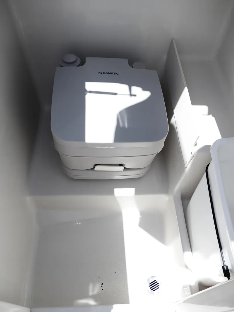 Slide: The Image of Portable toilet in 2026 Starcraft SVX 231 OB DH boat interior. - 26