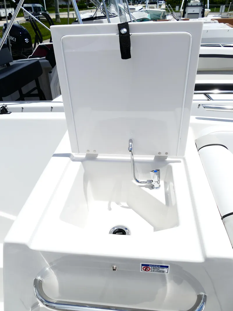 Slide: The Image of 2026 Starcraft SVX 231 OB DH boat sink with open lid and faucet. - 38