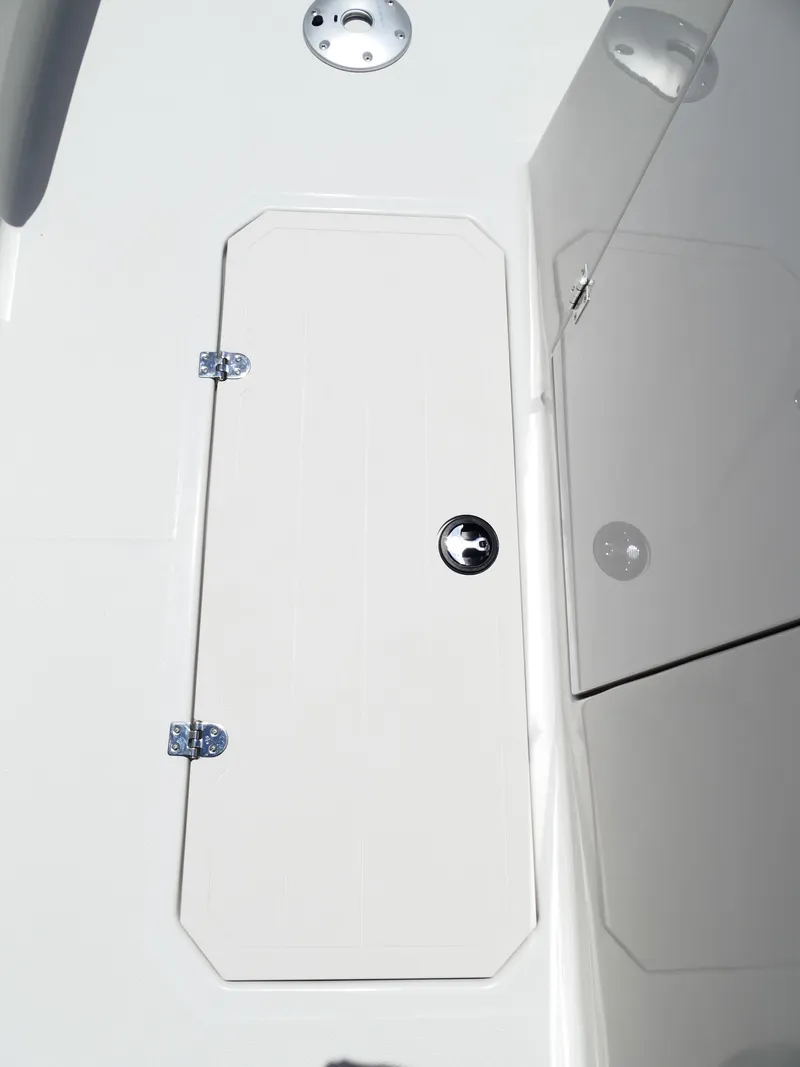Slide: The Image of 2026 Starcraft SVX 231 OB DH boat storage compartment with sleek white finish. - 39