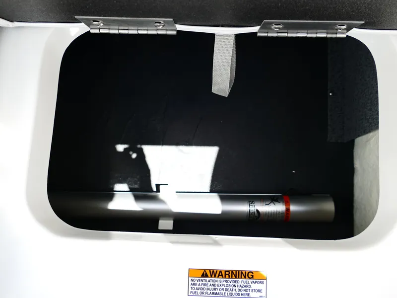 Slide: The Image of Storage compartment of 2026 Starcraft SVX 231 OB DH boat with warning label. - 43