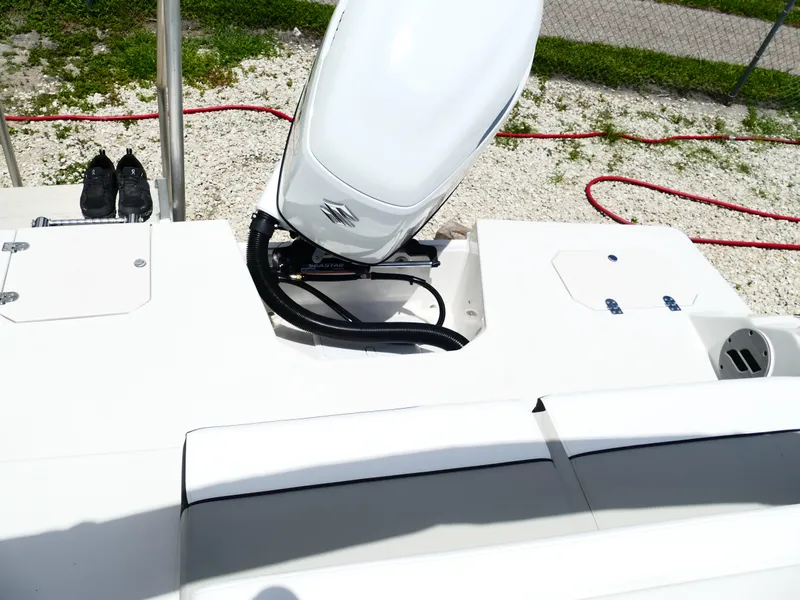 Slide: The Image of 2026 Starcraft SVX 231 OB DH boat with Suzuki outboard motor, white deck, and storage compartments. - 47