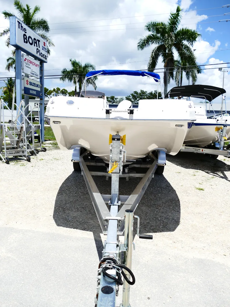 Slide: The Image of 2026 Starcraft SVX 231 OB DH boat on trailer at dealership, sunny day. - 6