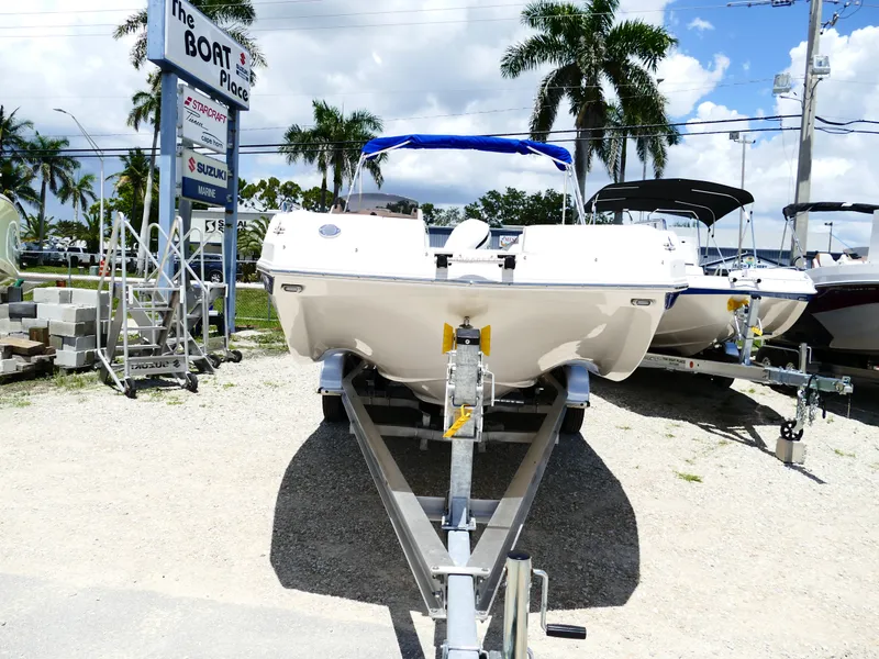 Slide: The Image of 2026 Starcraft SVX 231 OB DH boat on trailer at dealership, sunny day. - 7