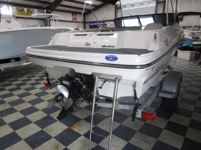Slide: The Image of 2021 Bayliner VR4 Bowrider I/O in showroom, rear view with ladder and propeller. - 12