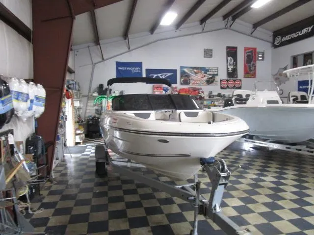 Slide: The Image of 2021 Bayliner VR4 Bowrider I/O in showroom, checkered floor, surrounded by boating equipment. - 3