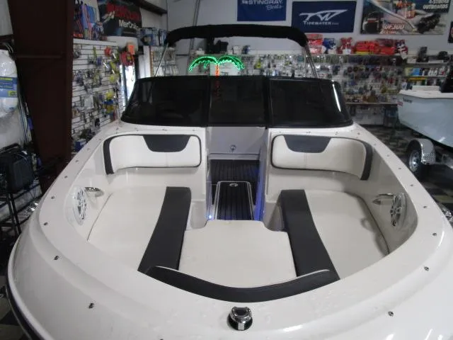 Slide: The Image of 2021 Bayliner VR4 Bowrider I/O interior with seating and dashboard in showroom. - 4