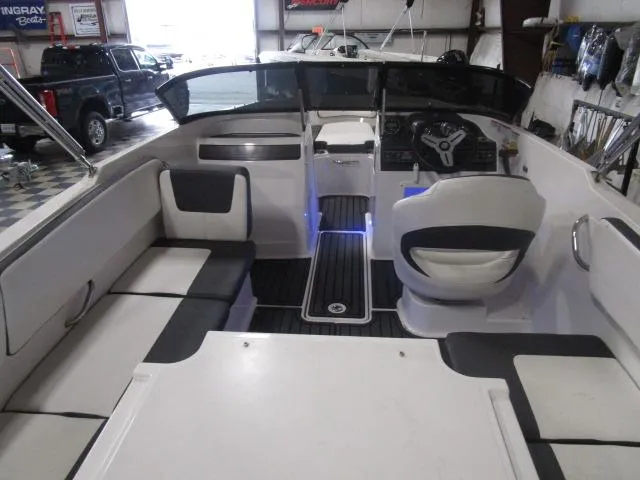Slide: The Image of 2021 Bayliner VR4 Bowrider I/O interior with seating and steering wheel in a showroom. - 5