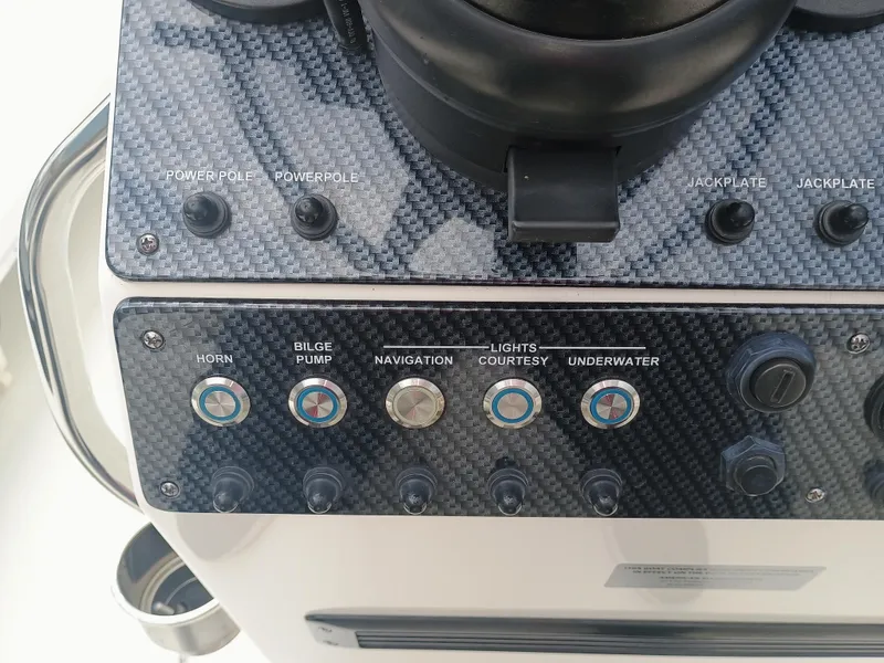Slide: The Image of Control panel of a 2023 Sterling 180TS boat with various switches and buttons. - 10
