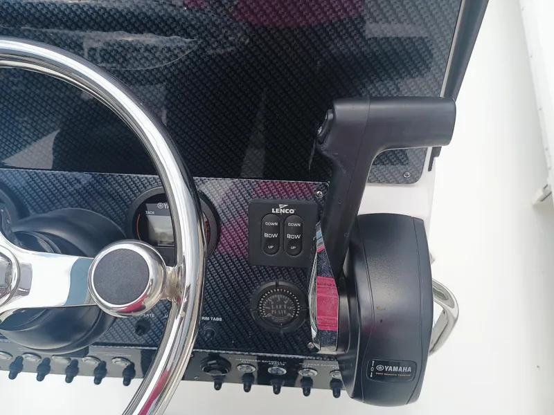 Slide: The Image of Steering wheel and controls of 2023 Sterling 180TS boat, featuring Yamaha throttle. - 11