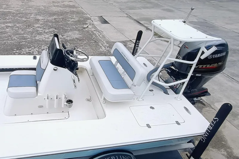 Slide: The Image of 2023 Sterling 180TS boat with Yamaha engine, featuring white and blue seating. - 22