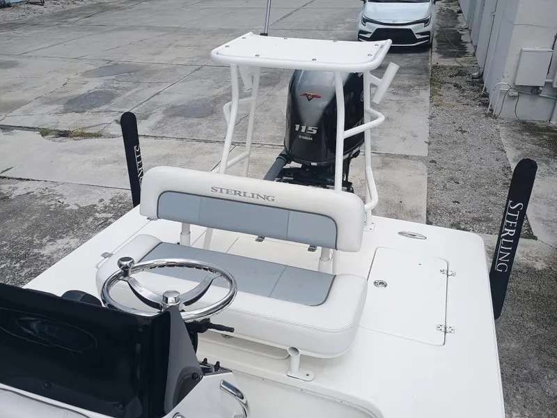 Slide: The Image of 2023 Sterling 180TS boat with Yamaha 115 engine, docked on concrete surface. - 6