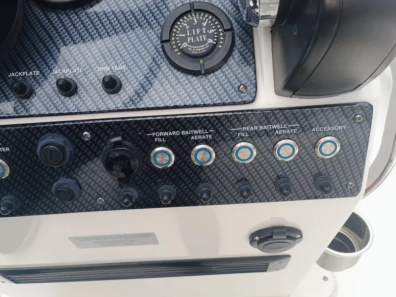 Slide: The Image of Control panel of 2023 Sterling 180TS boat with various switches and gauges. - 9