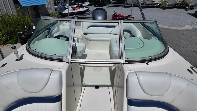 Slide: The Image of 2008 Hurricane 220 Sun Deck boat interior with white and blue seating. - 11