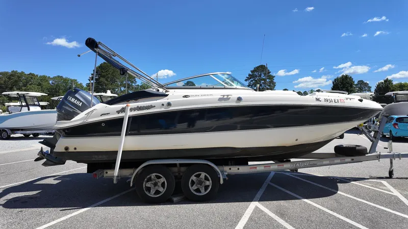 Slide: The Image of 2008 Hurricane 220 Sun Deck boat on trailer under clear blue sky. - 3