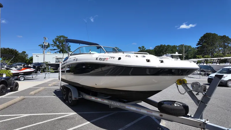 Slide: The Image of 2008 Hurricane 220 Sun Deck boat on trailer under clear blue sky. - 4