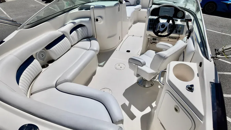Slide: The Image of 2008 Hurricane 220 Sun Deck boat interior with white seating and steering console. - 6