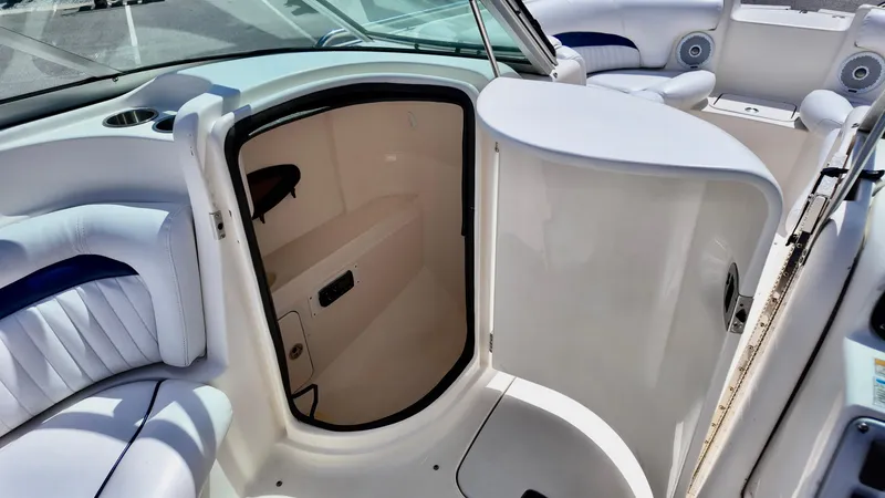 Slide: The Image of 2008 Hurricane 220 Sun Deck interior with open storage compartment and cushioned seating. - 8