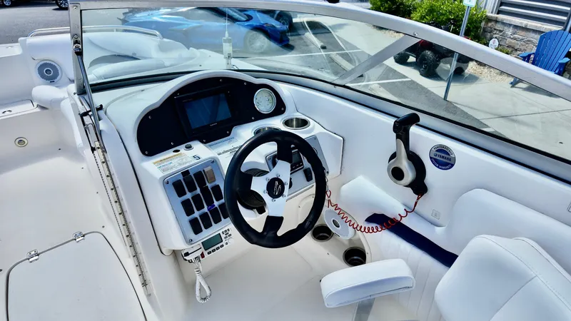 Slide: The Image of 2008 Hurricane 220 Sun Deck boat cockpit with steering wheel and control panel. - 9