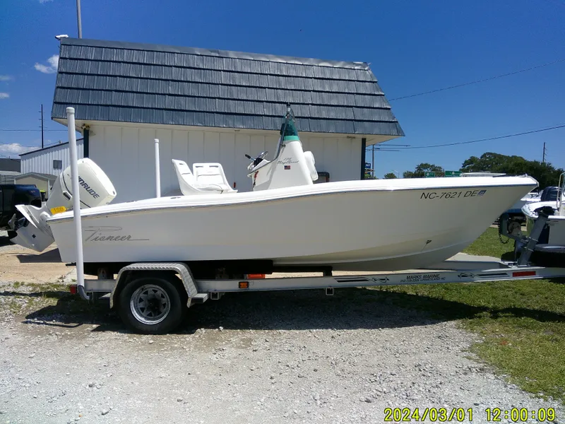Slide: The Image of 2006 Pioneer 175 Bay Sport boat on trailer, parked outdoors under clear blue sky. - 1