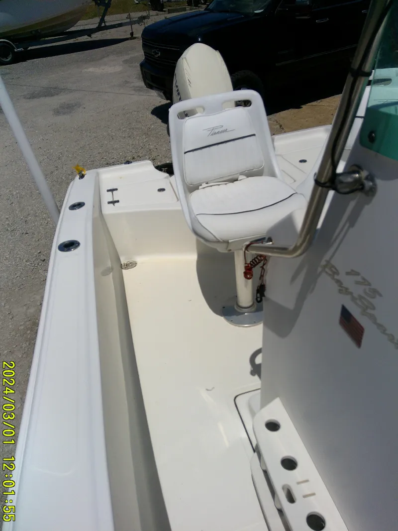 Slide: The Image of 2006 Pioneer 175 Bay Sport boat interior with white seating and console. - 14
