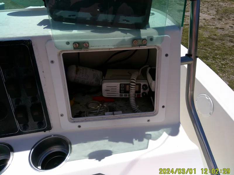 Slide: The Image of Open storage compartment on a 2006 Pioneer 175 Bay Sport boat console. - 18