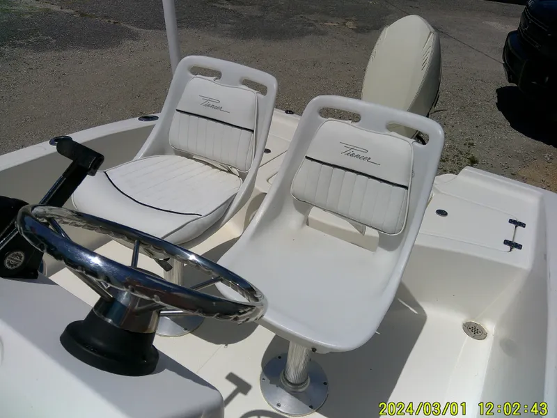 Slide: The Image of 2006 Pioneer 175 Bay Sport boat interior with white seats and steering wheel. - 19