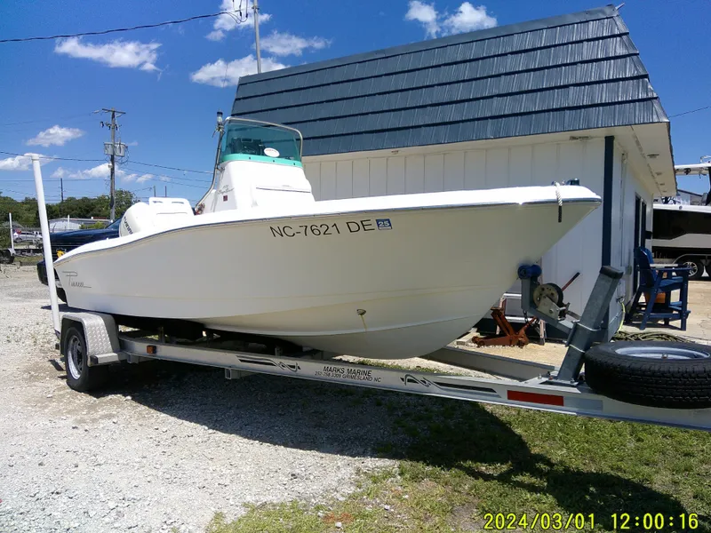 Slide: The Image of 2006 Pioneer 175 Bay Sport boat on trailer, parked outdoors under blue sky. - 2