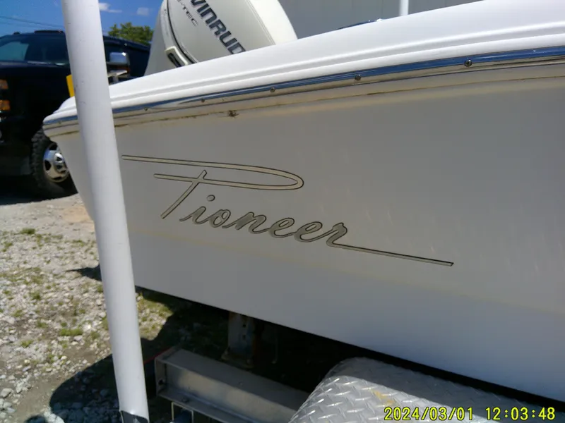 Slide: The Image of 2006 Pioneer 175 Bay Sport boat on trailer, side view with logo visible. - 23
