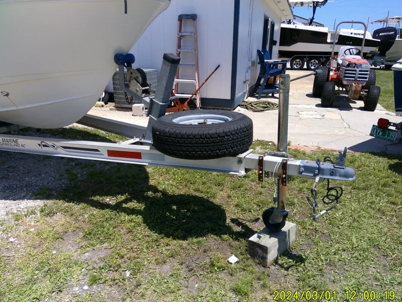Slide: The Image of Trailer of 2006 Pioneer 175 Bay Sport boat with spare tire, parked outdoors. - 3