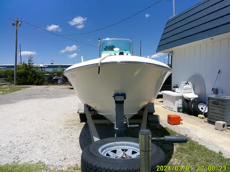 Slide: The Image of 2006 Pioneer 175 Bay Sport boat on trailer, parked outdoors under clear blue sky. - 4