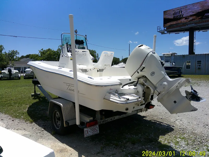 Slide: The Image of 2006 Pioneer 175 Bay Sport boat on trailer, parked outdoors under clear blue sky. - 6