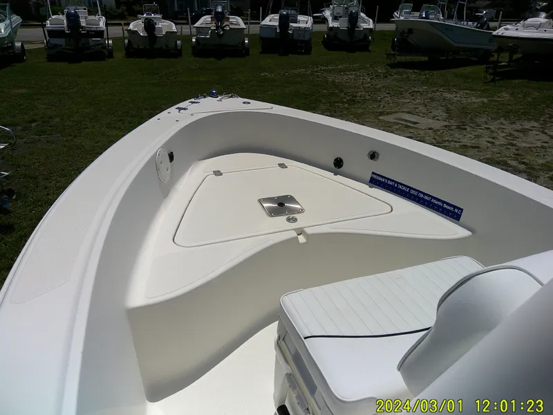 Slide: The Image of 2006 Pioneer 175 Bay Sport boat interior with seating and storage, displayed outdoors. - 9