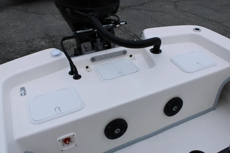 Slide: The Image of 2025 Sundance B22CCR boat deck with storage compartments and motor. - 15