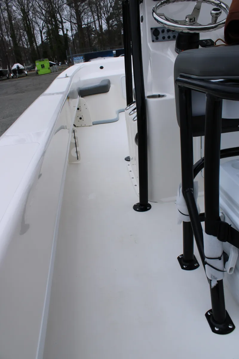 Slide: The Image of 2025 Sundance B22CCR boat interior with sleek white deck and modern seating. - 17