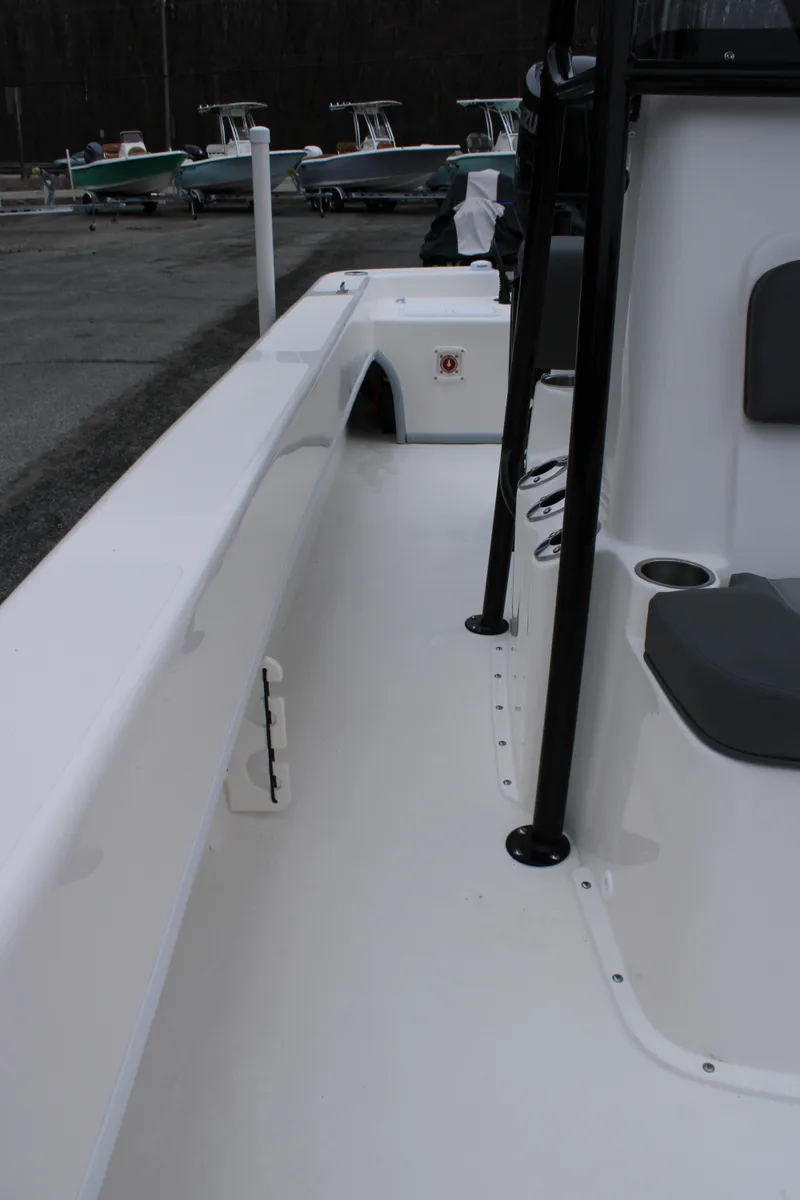 Slide: The Image of 2025 Sundance B22CCR boat interior with seating and storage compartments. - 19