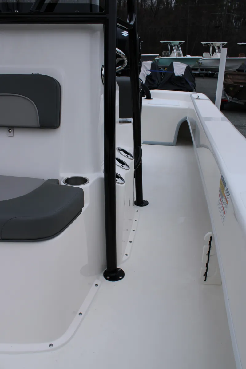 Slide: The Image of 2025 Sundance B22CCR boat interior with seating and cup holder, showcasing sleek design. - 20