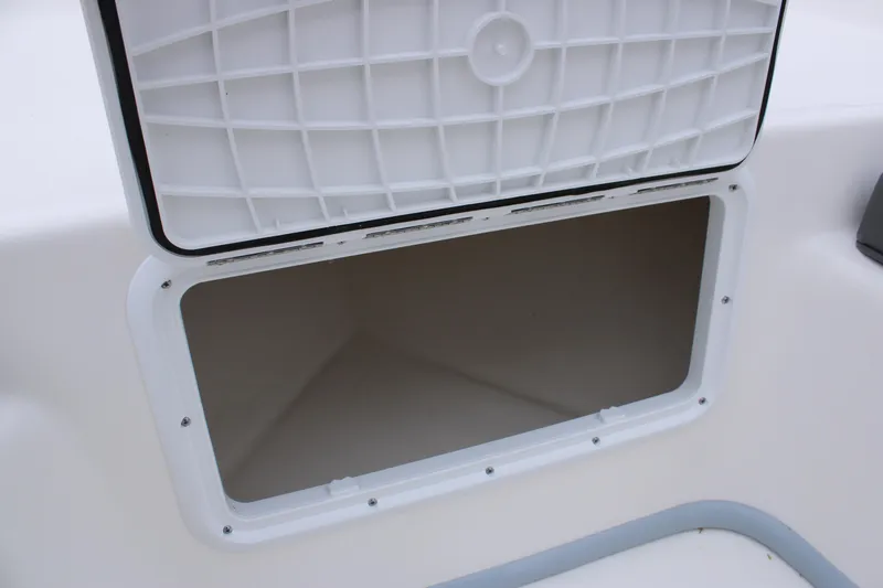 Slide: The Image of Open storage compartment on 2025 Sundance B22CCR boat. - 22