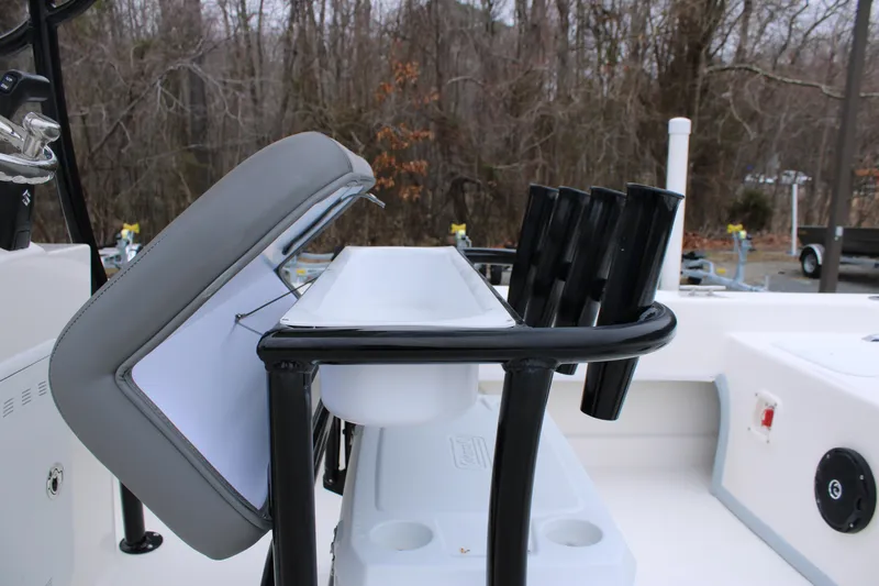 Slide: The Image of 2025 Sundance B22CCR boat interior with rod holders and storage compartment. - 23