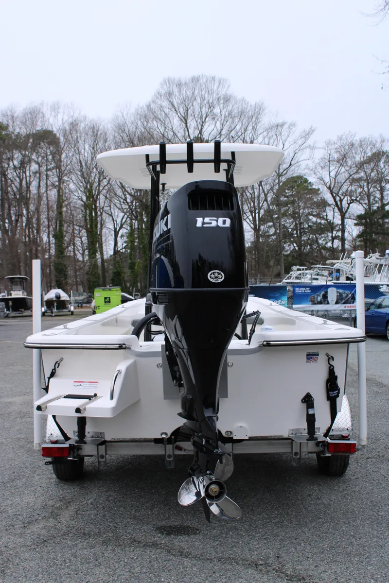 Slide: The Image of 2025 Sundance B22CCR boat with 150 HP engine, parked outdoors. - 3