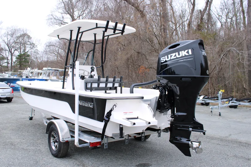 Slide: The Image of 2025 Sundance B22CCR boat with Suzuki outboard motor on a trailer. - 5