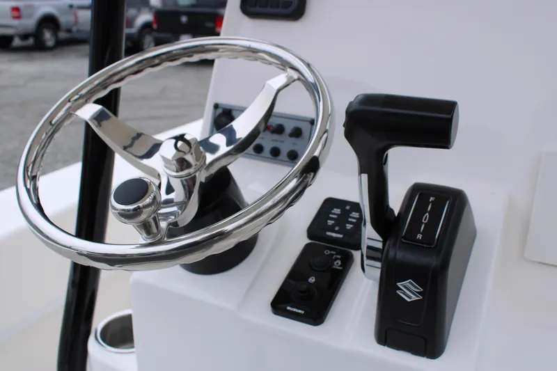 Slide: The Image of Steering wheel and controls of 2025 Sundance B22CCR boat. - 9