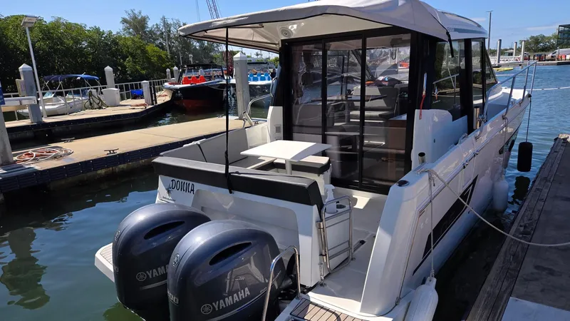 Slide: The Image of 2019 Jeanneau NC895 boat docked with twin Yamaha engines. - 1