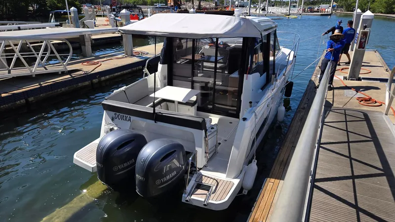 Slide: The Image of 2019 Jeanneau NC895 boat docked with twin Yamaha outboard engines. - 2