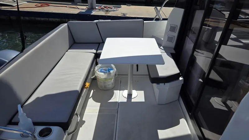 Slide: The Image of 2019 Jeanneau NC895 boat with outdoor seating and table on deck. - 4