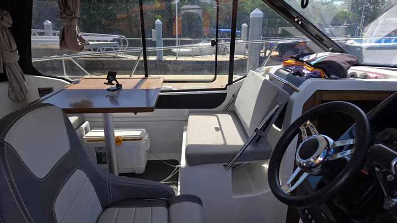 Slide: The Image of Interior of 2019 Jeanneau NC895 boat with seating and steering wheel. - 6